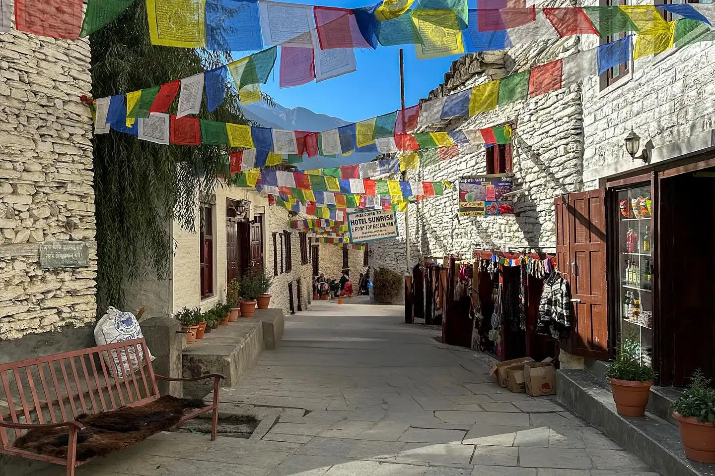Prayer flags over the whitewashed flagstone lane of Marpha, near Jomsom