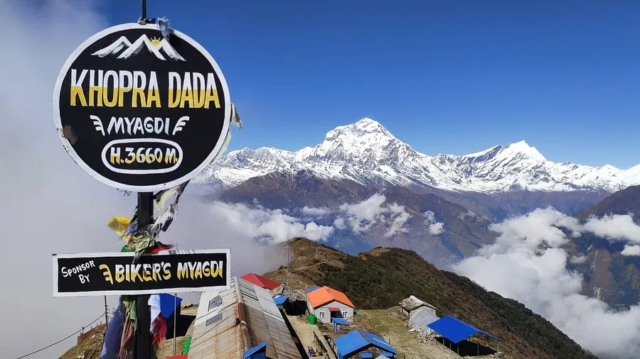 Khopra Danda sign at 3,660 m, with Dhaulagiri floating above the clouds